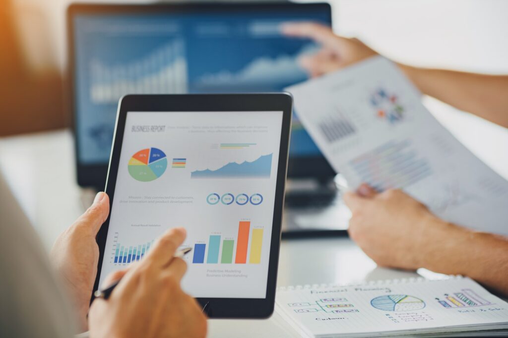 two businessman investment consultant analyzing company annual financial report balance 1